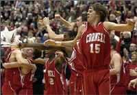 Cornell's Geoff Reeves (15) and his teammates celebrate after defeating Harvard to clinch their first Ivy League championship in 20 years. The title means the Big Red have earned the league's automatic bid to the NCAA tournament.